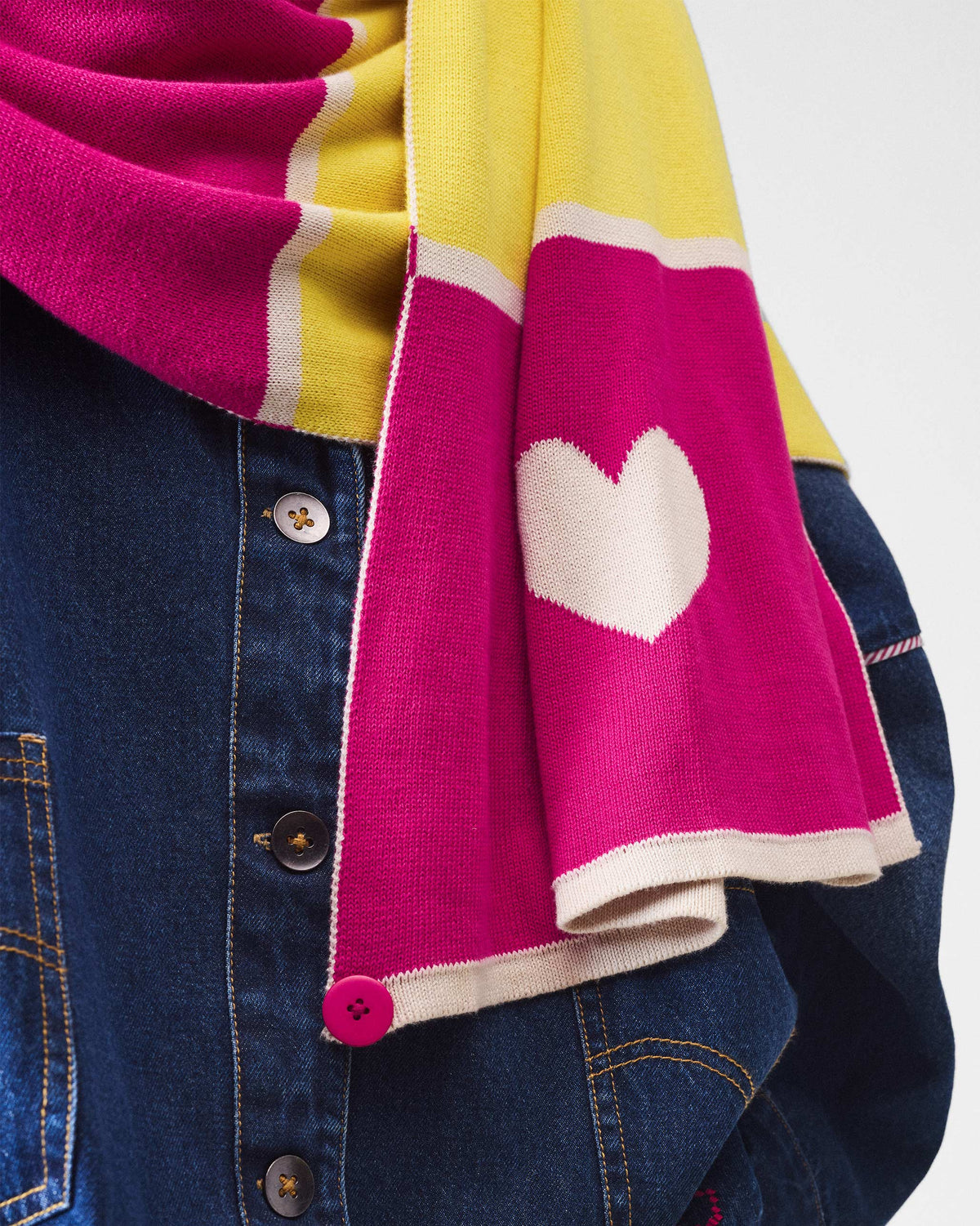 Close-up of the Chromatic Crossroads scarf showing a white knitted heart on pink.