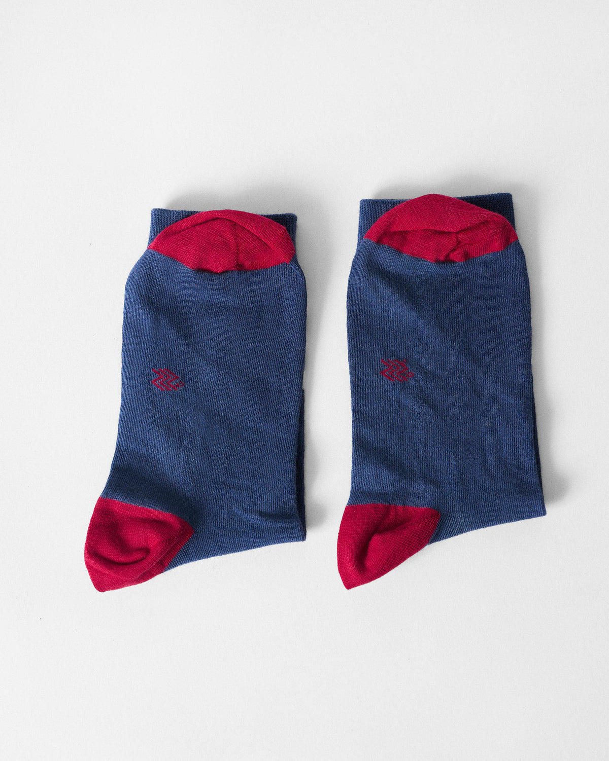 Pair of navy Starbed Socks showing red heels and toes.