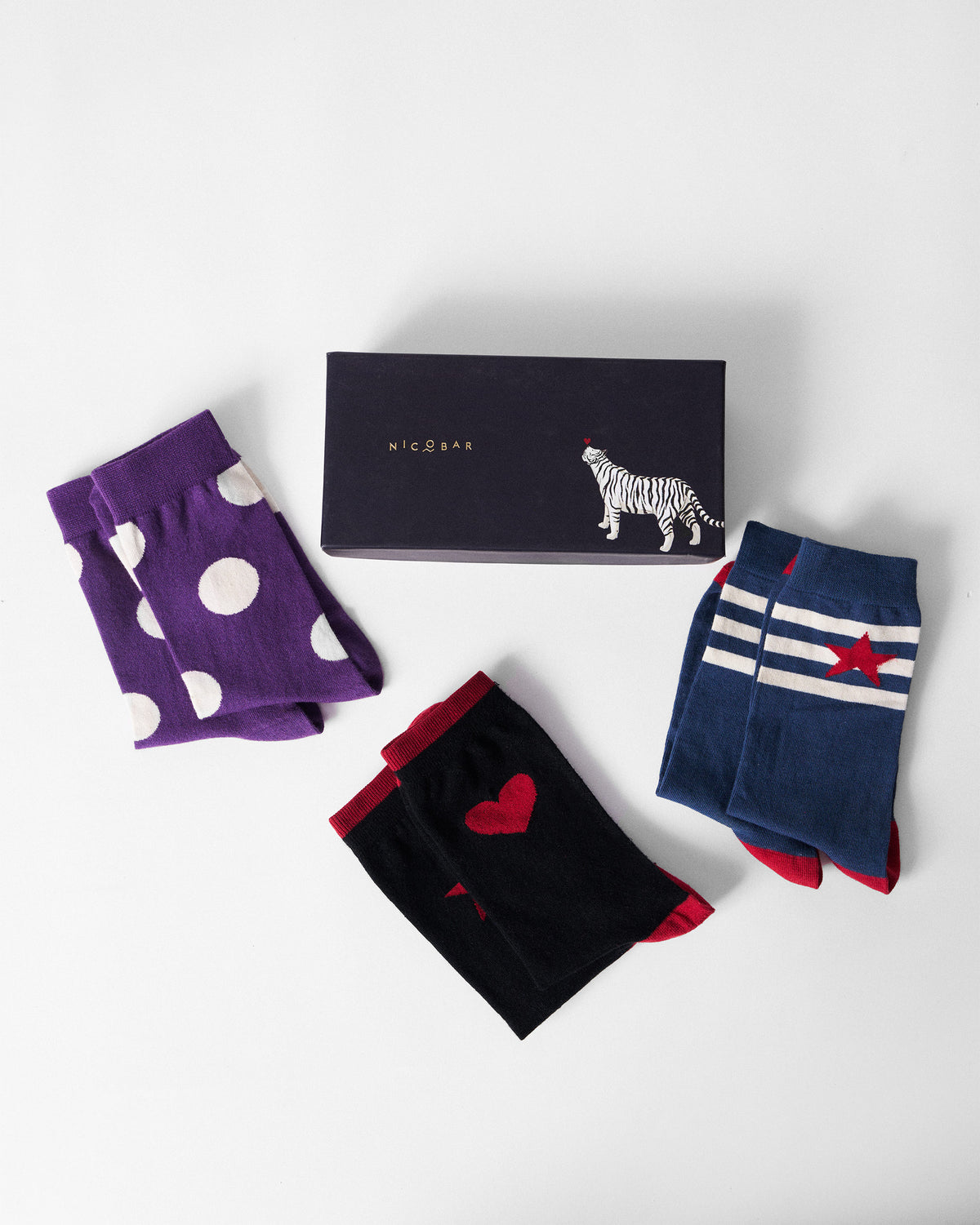 Nicobar sock gift set with navy Starbed Socks beside polka and heart pairs.