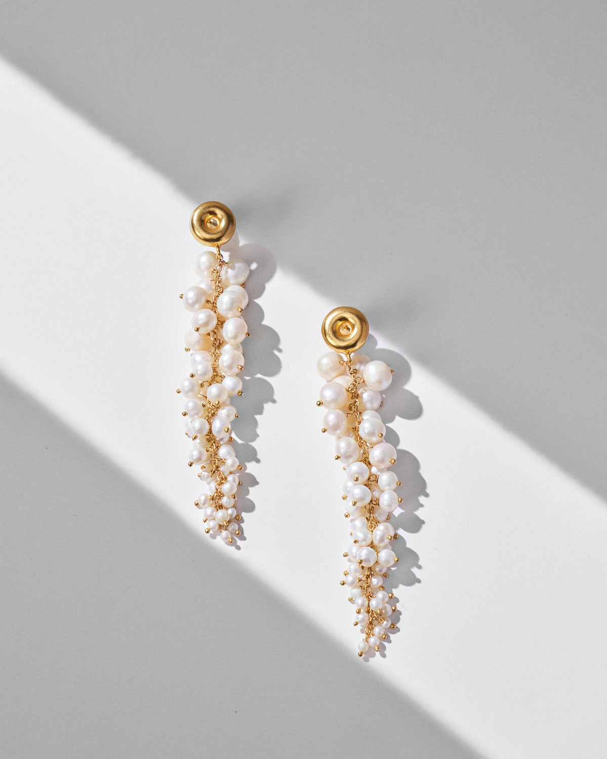 Pair of gold Mogra shoulder dusters with cascading pearl clusters.