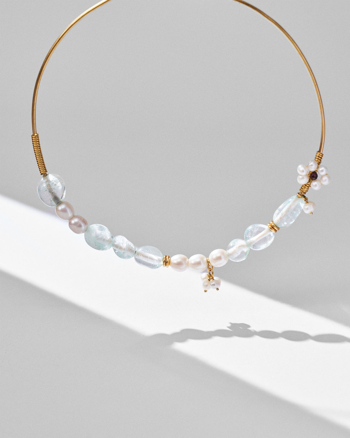 Noorani gold wire choker with pale blue stones and pearl charms.