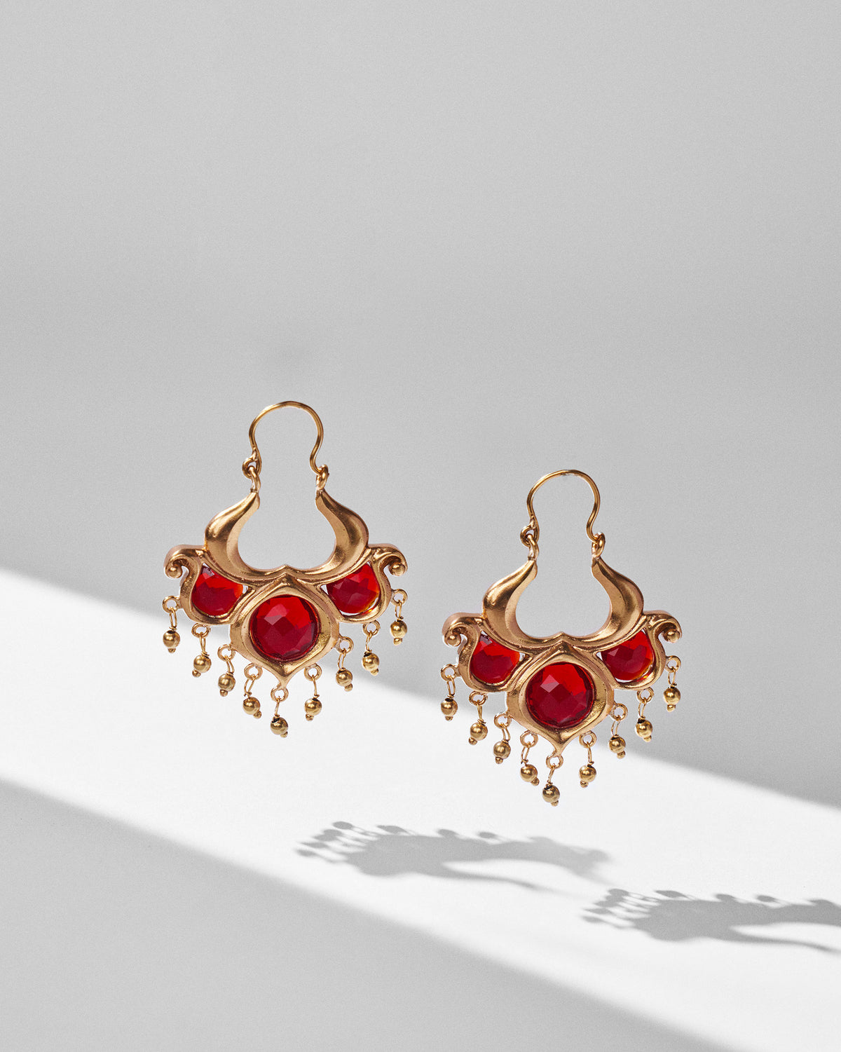 Pair of antique gold Darbaar Balis with red glass stones and bead fringe.