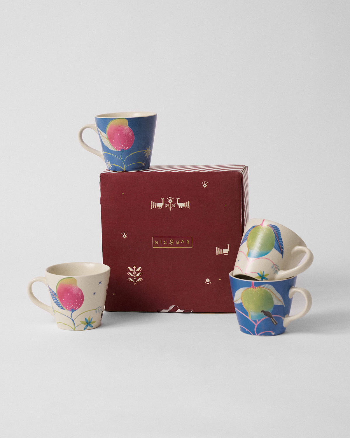 Ambi Espresso Mug set arranged around a maroon Nicobar gift box.