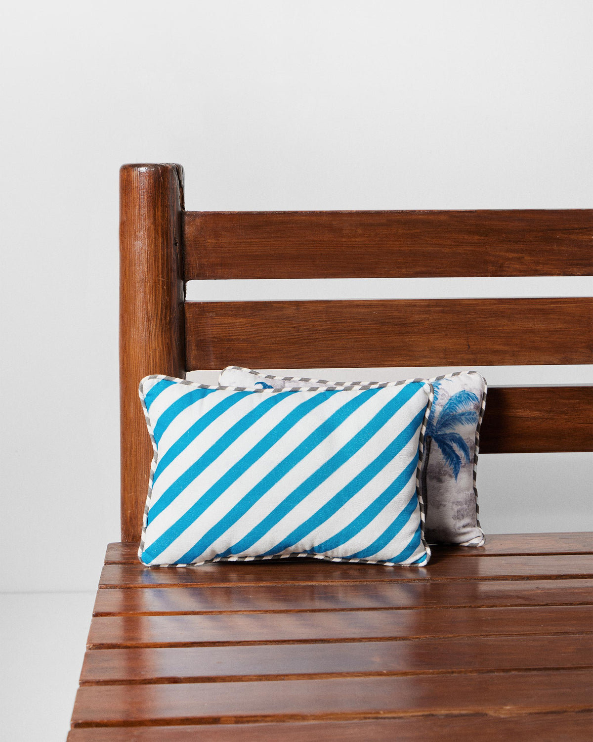 Sindhu car cushion with blue and white diagonal stripes.