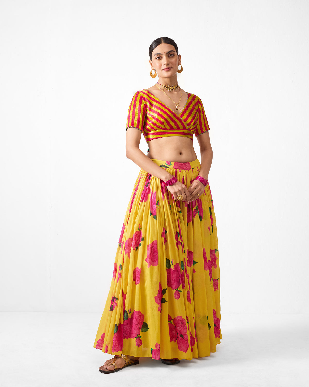 Full-length view of a yellow Reha skirt with a pink rose print.