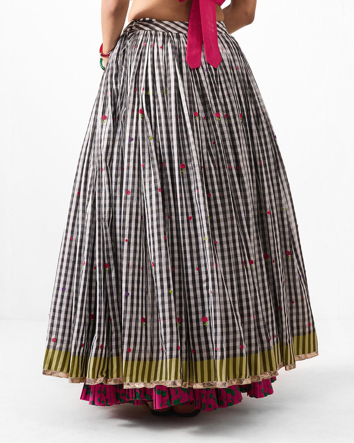 Back of a black and white gingham Sitara skirt with an olive striped hem.