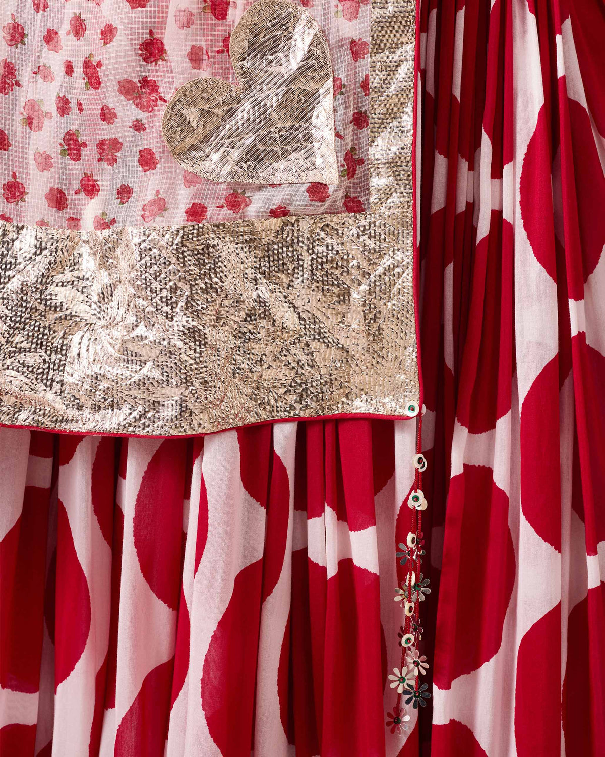 Close-up of Lehar dupatta with a gold heart motif and gota border.