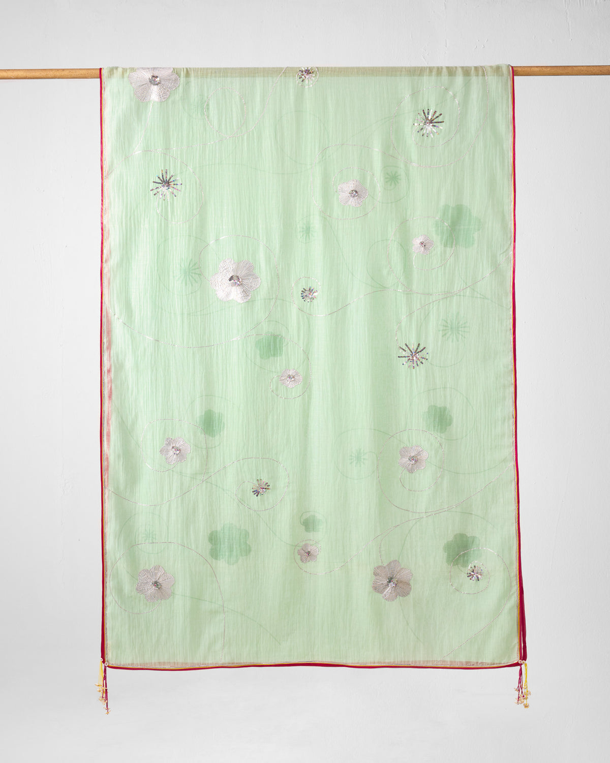 Sea blue embroidered Fiza Dupatta hung showing floral motifs and pink piping.