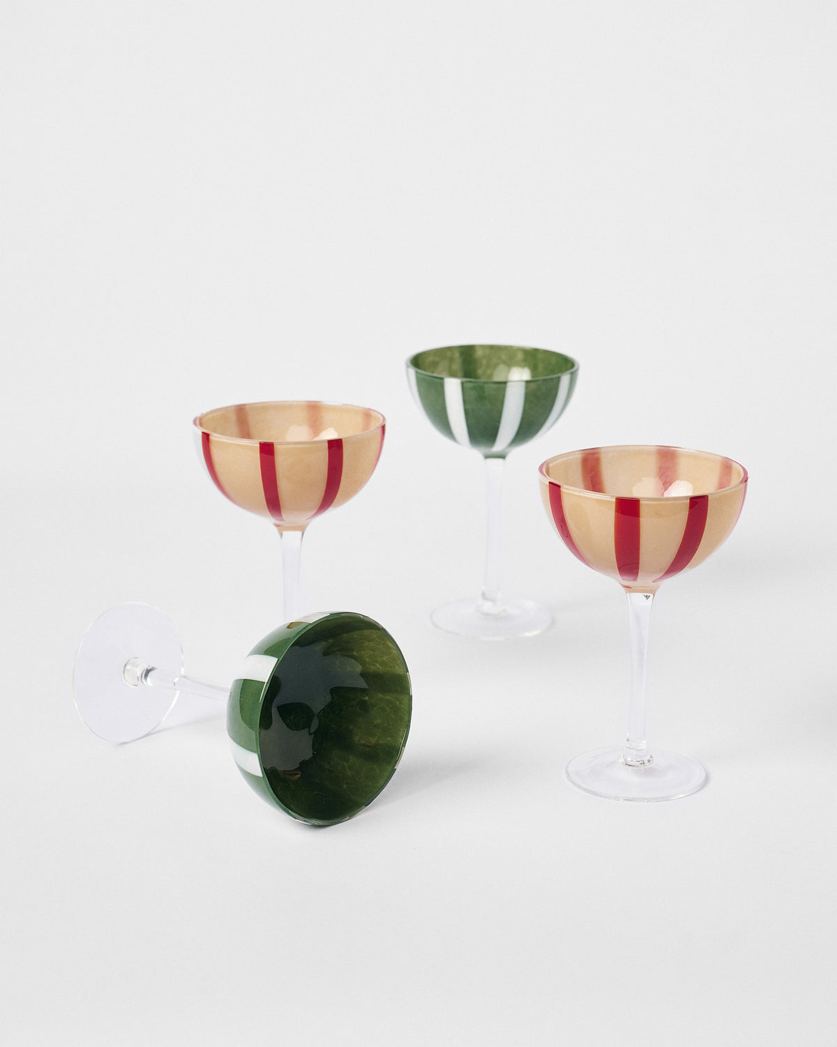 Lune cocktail glasses set of four, one turned upside down to show its green stripes.