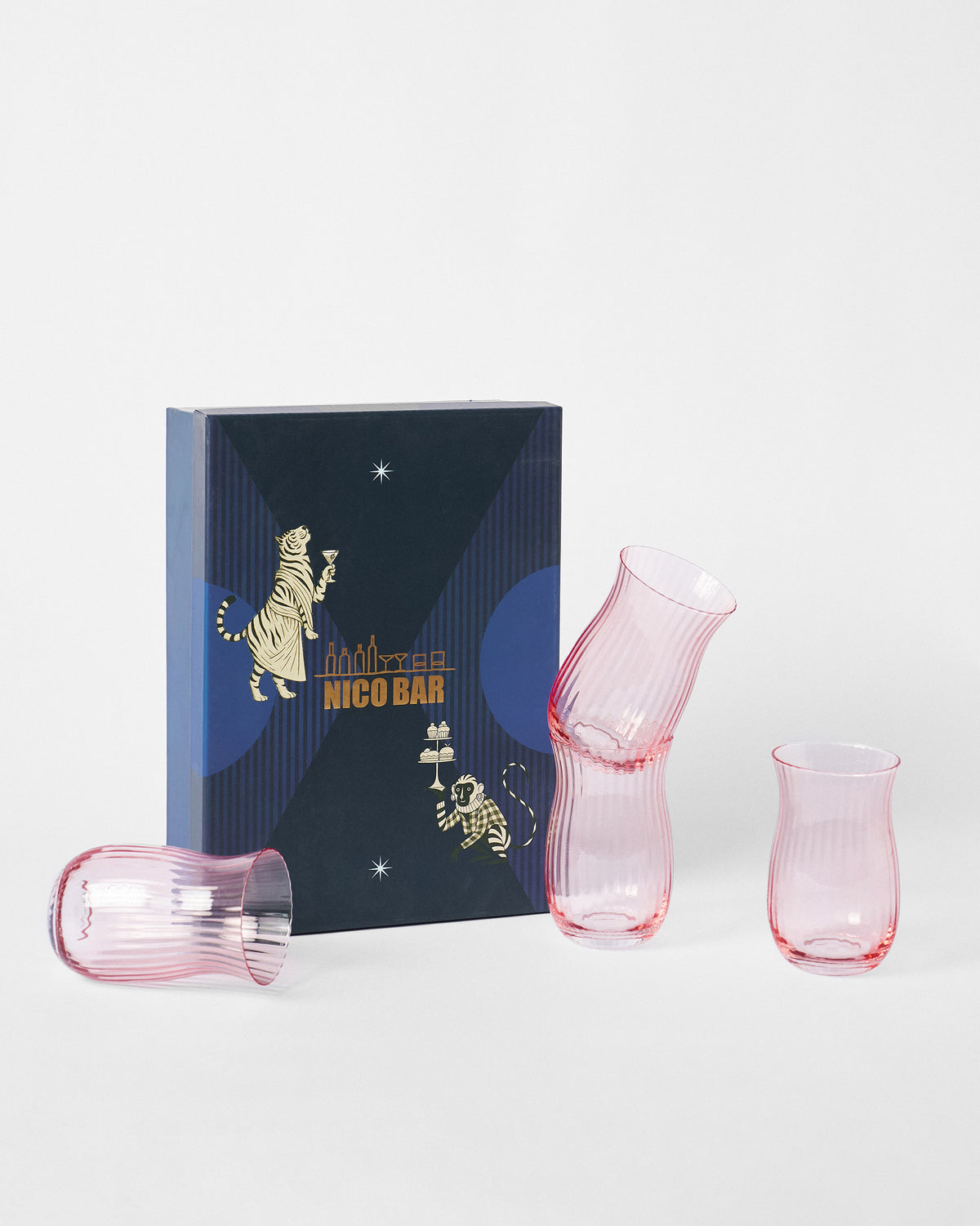 Pink Ripple tumblers in front of a navy NICO BAR gift box.