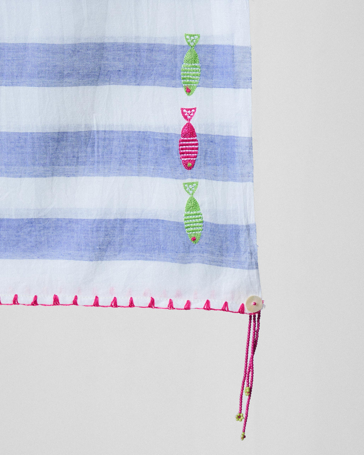 Close-up of Skyline scarf showing stacked embroidered fish on blue stripes.