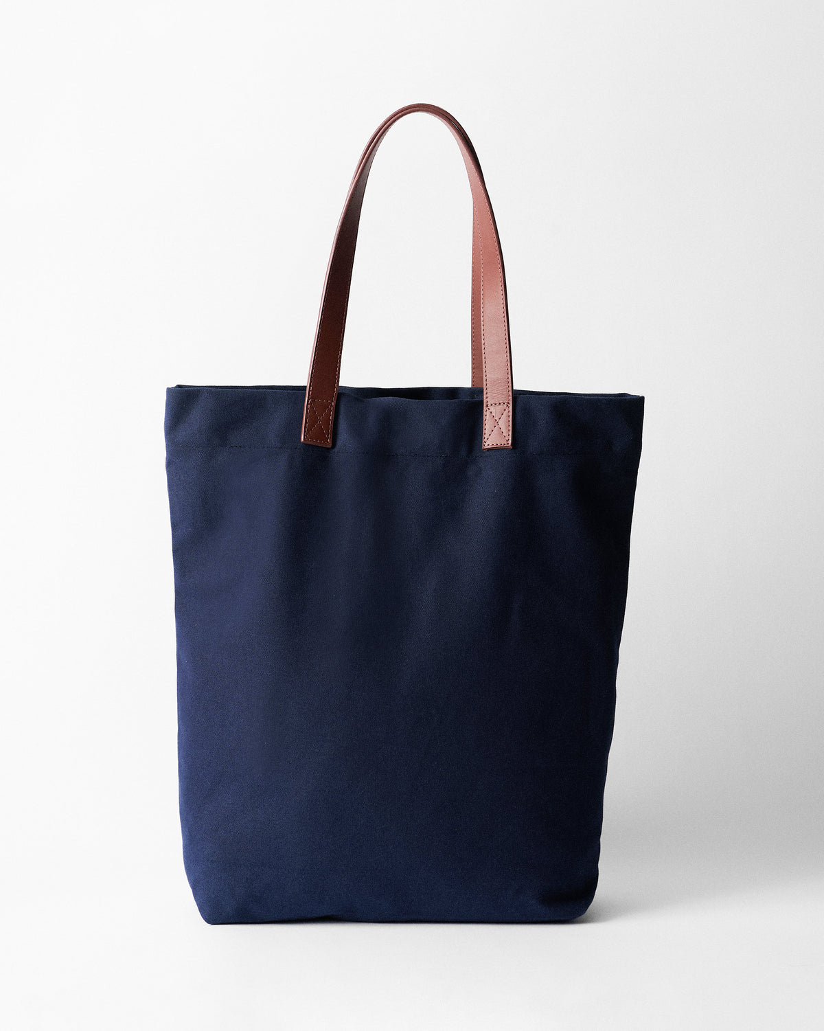 Navy Mukayu City tote with brown leather straps.