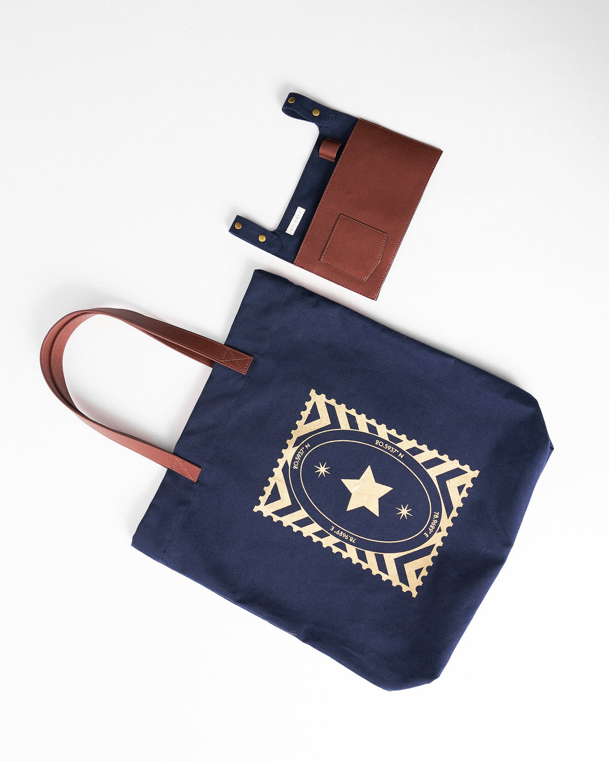 Navy Mukayu City tote laid flat with its leather organizer pouch.
