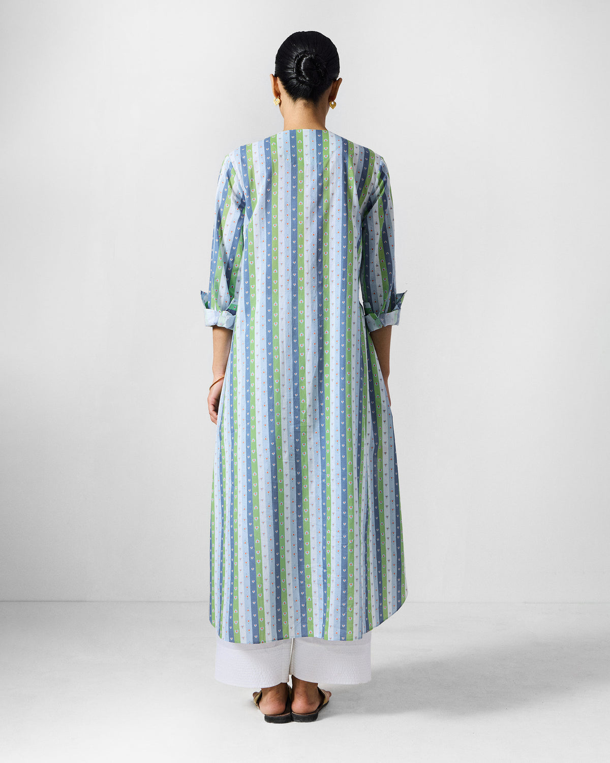 Back of an Imke Kurta in blue and green stripes worn by a person.