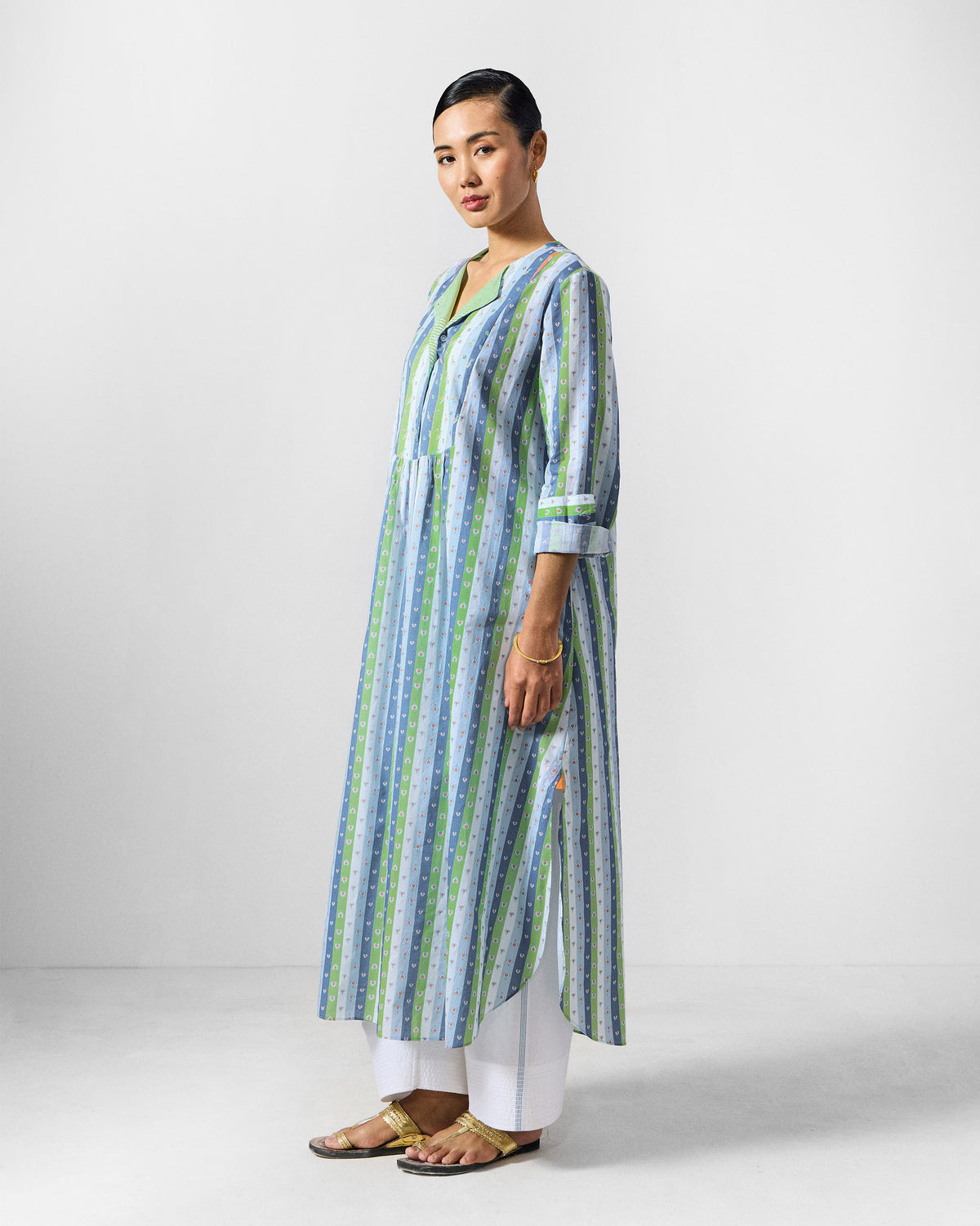 Side view of a striped Imke Kurta showing its side slits.