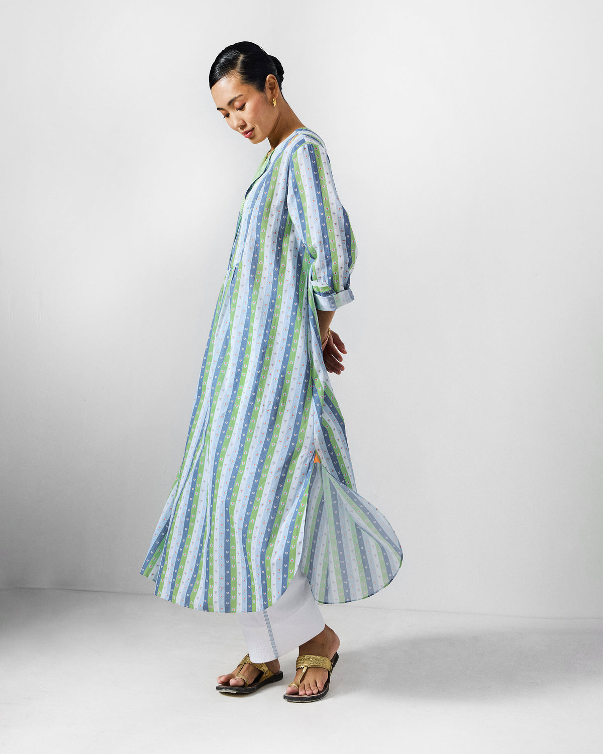 Side view of a striped Imke Kurta with a curved, flared hem.