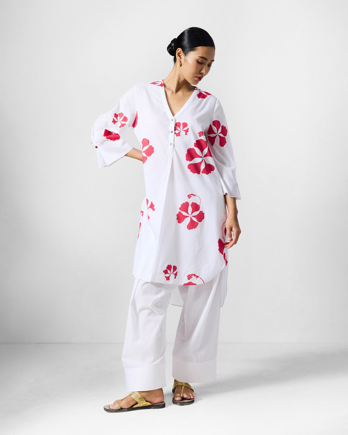 Person wearing a white and red printed Pampa kurta with a flared A-line hem.