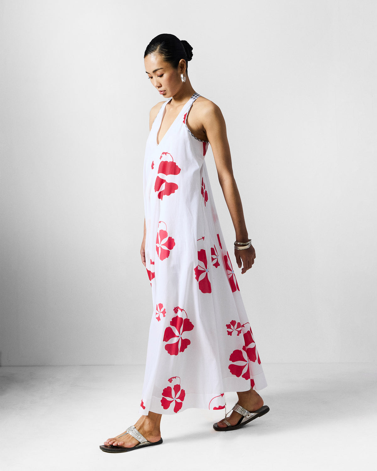 Side view of a white Anya Dress with a red gulmohar print.