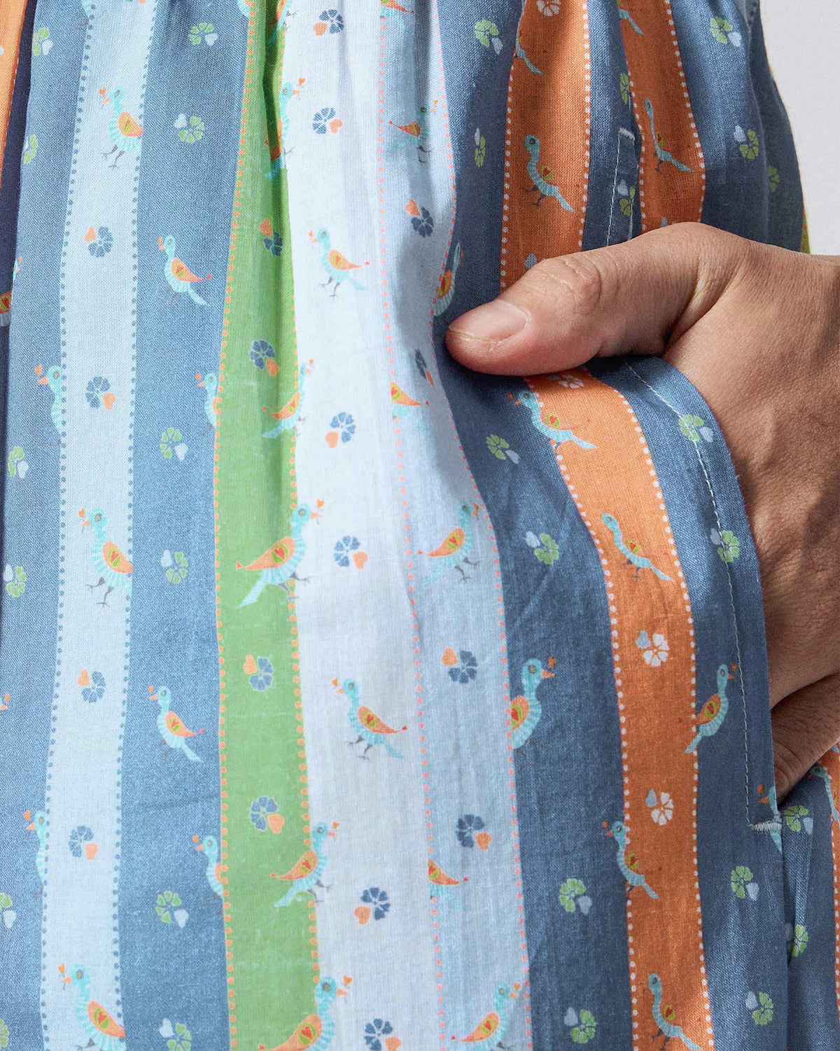 Close-up of Classic Pyjamas showing peeping bird print and a side pocket.