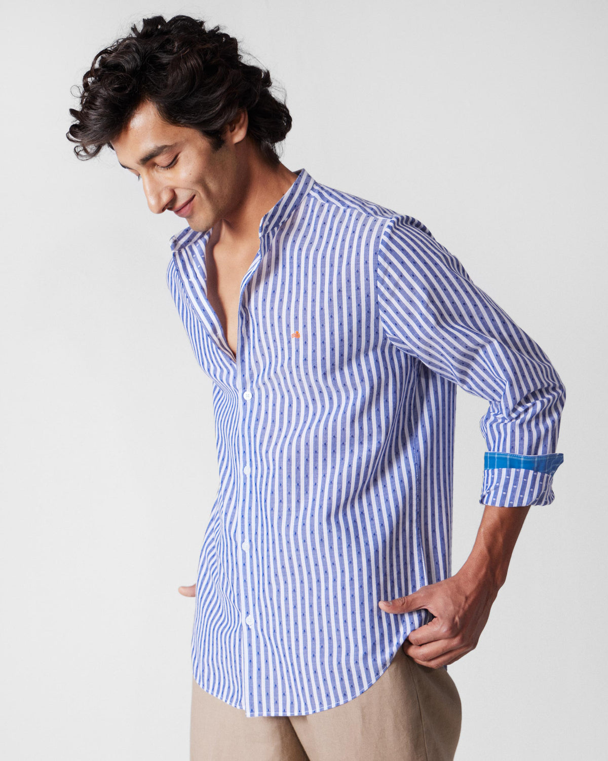 Person wearing a navy and white striped Nawab shirt with a Nehru collar.