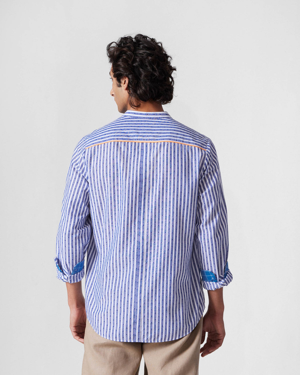 Back of a navy and white striped Nawab shirt with orange yoke piping.