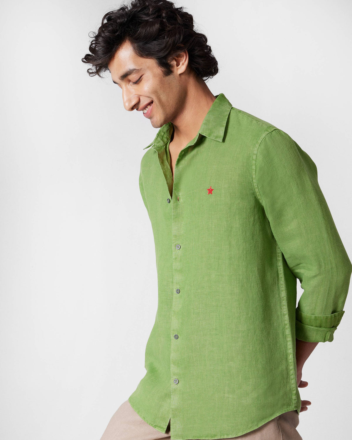 Person wearing a dark green Classic Shirt with a red chest star.