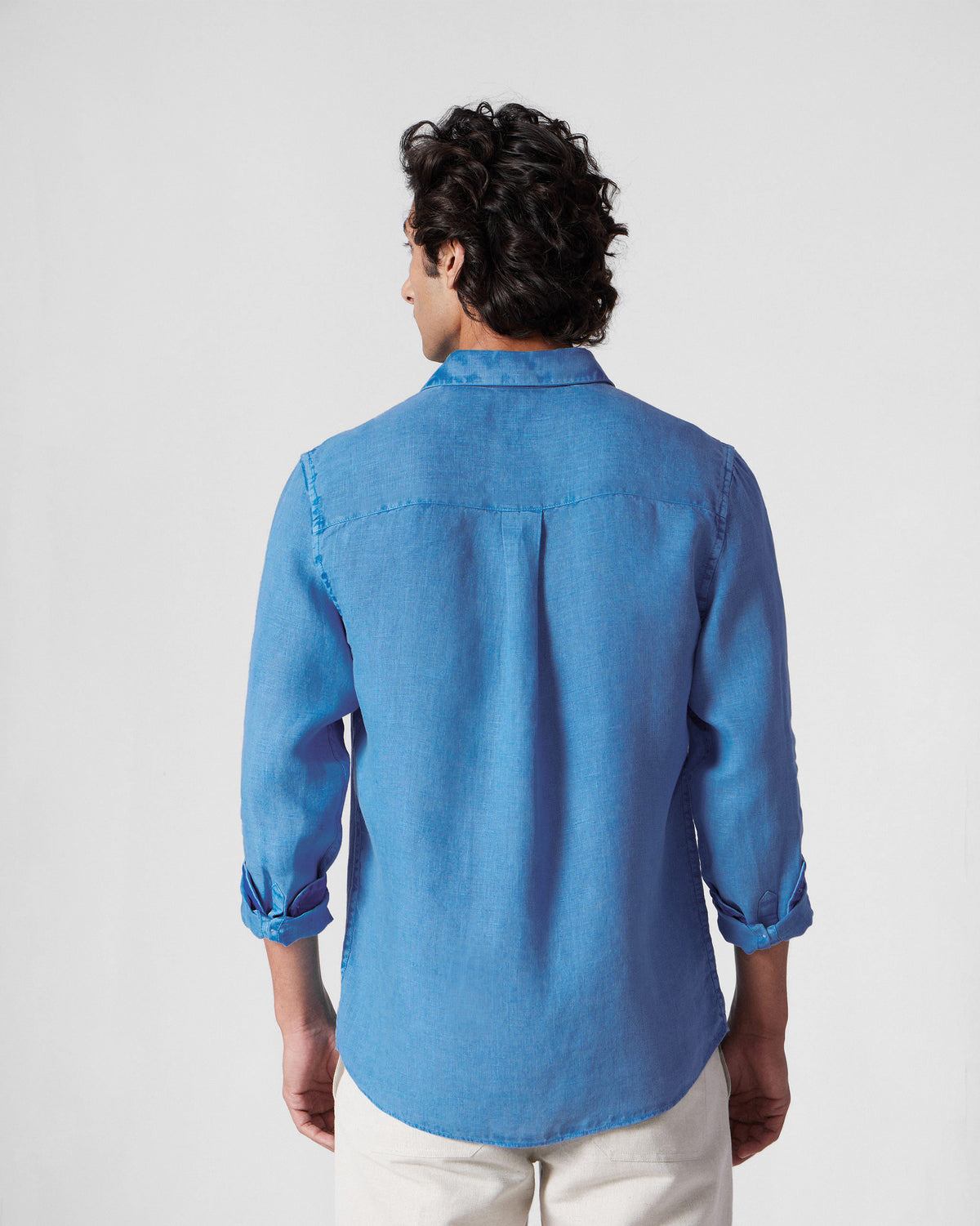 Back of a light blue Classic Shirt showing the yoke and center box pleat.