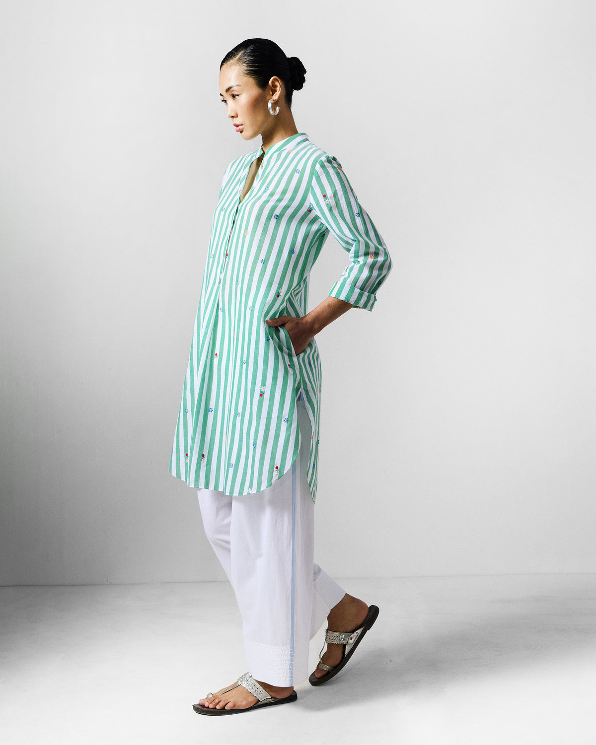 Side view of a green and white striped embroidered kurta with a side pocket.