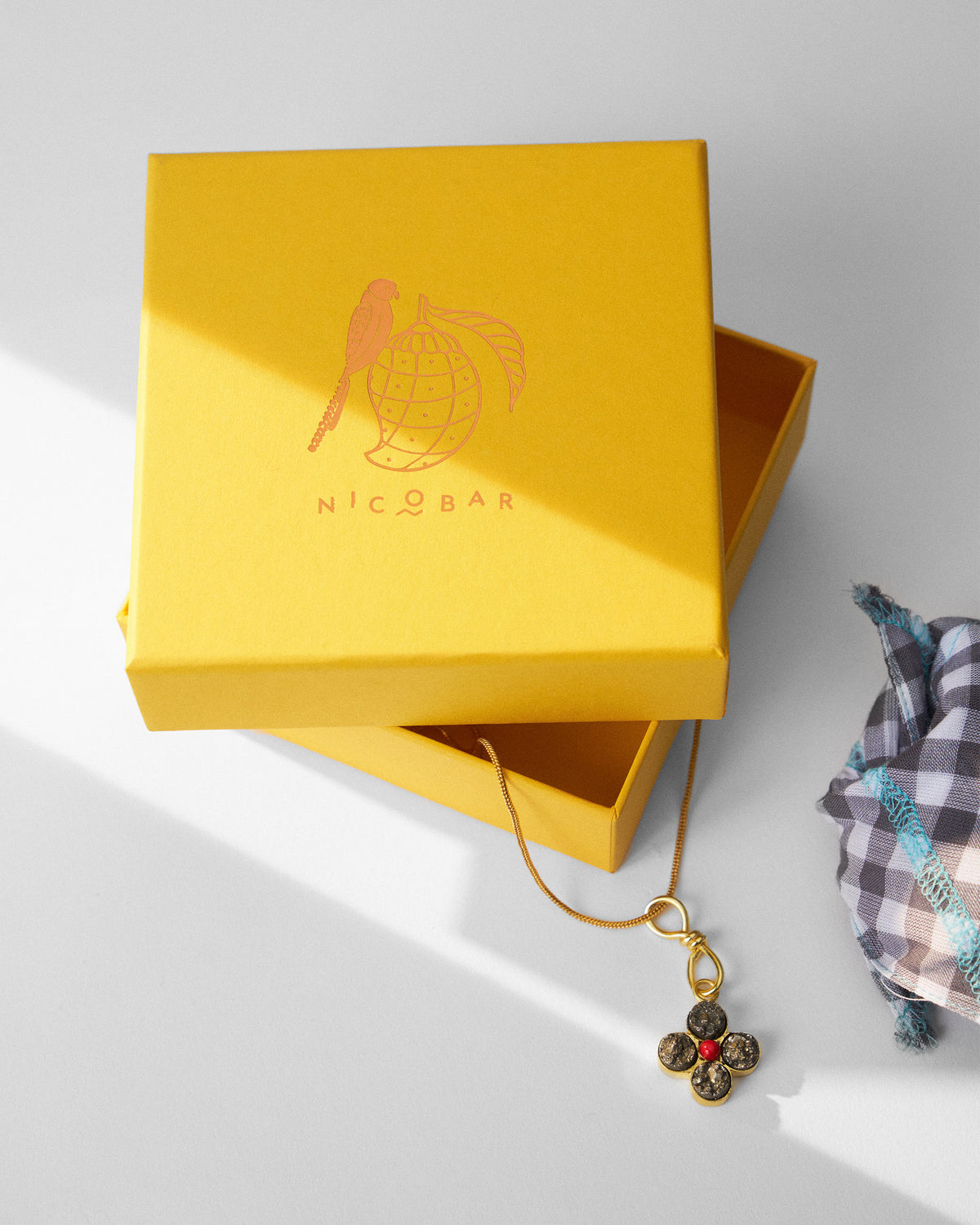 Gold Sindhu necklace with a yellow Nicobar gift box.