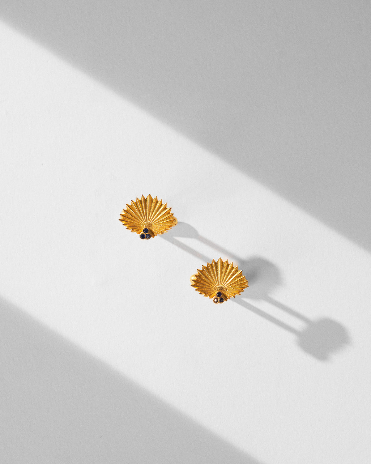 Pair of gold Palm Leaf Cufflinks laid flat, showing fan-shaped fronts.