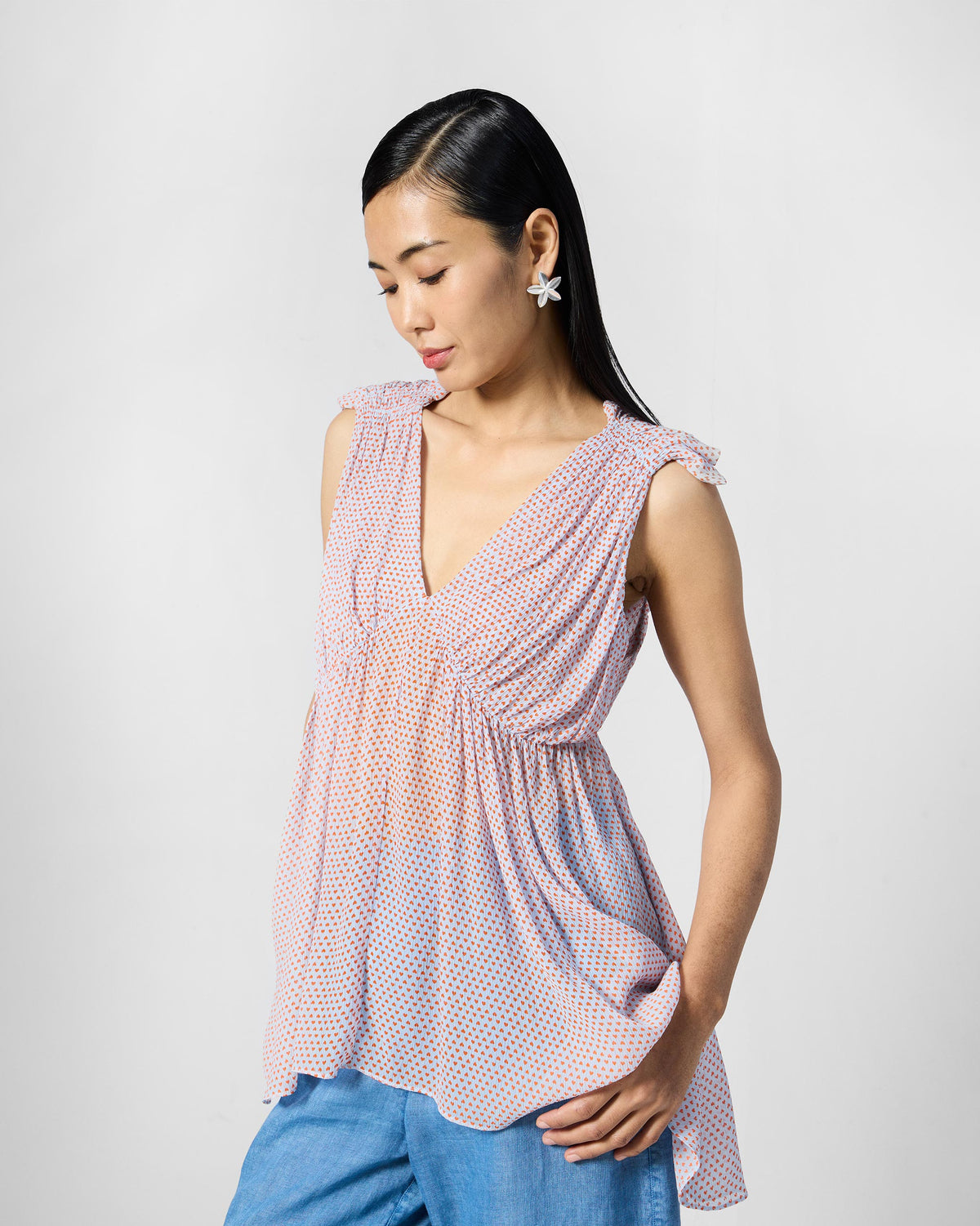 Person wearing a blue printed Sira top, turned to show the gathered bodice.