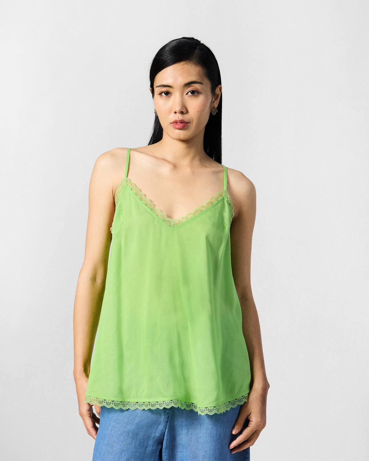 Lime green slip for the Jora top with scalloped lace at the neckline and hem.