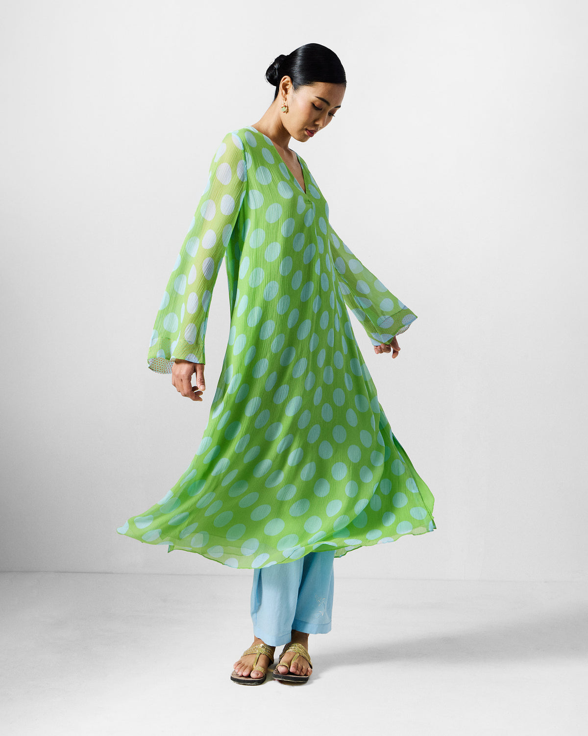 Person wearing a green and blue dotted Pleated Bell Sleeve kurta.