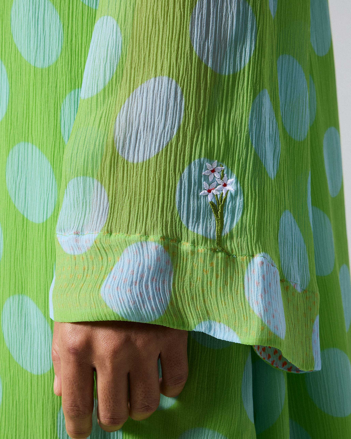 Close-up of a Pleated Bell Sleeve kurta cuff with tiny flower embroidery.