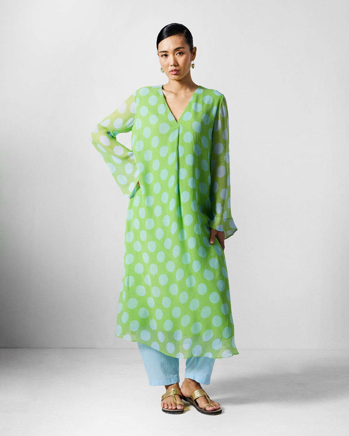 Person wearing a green and blue dotted midi kurta.