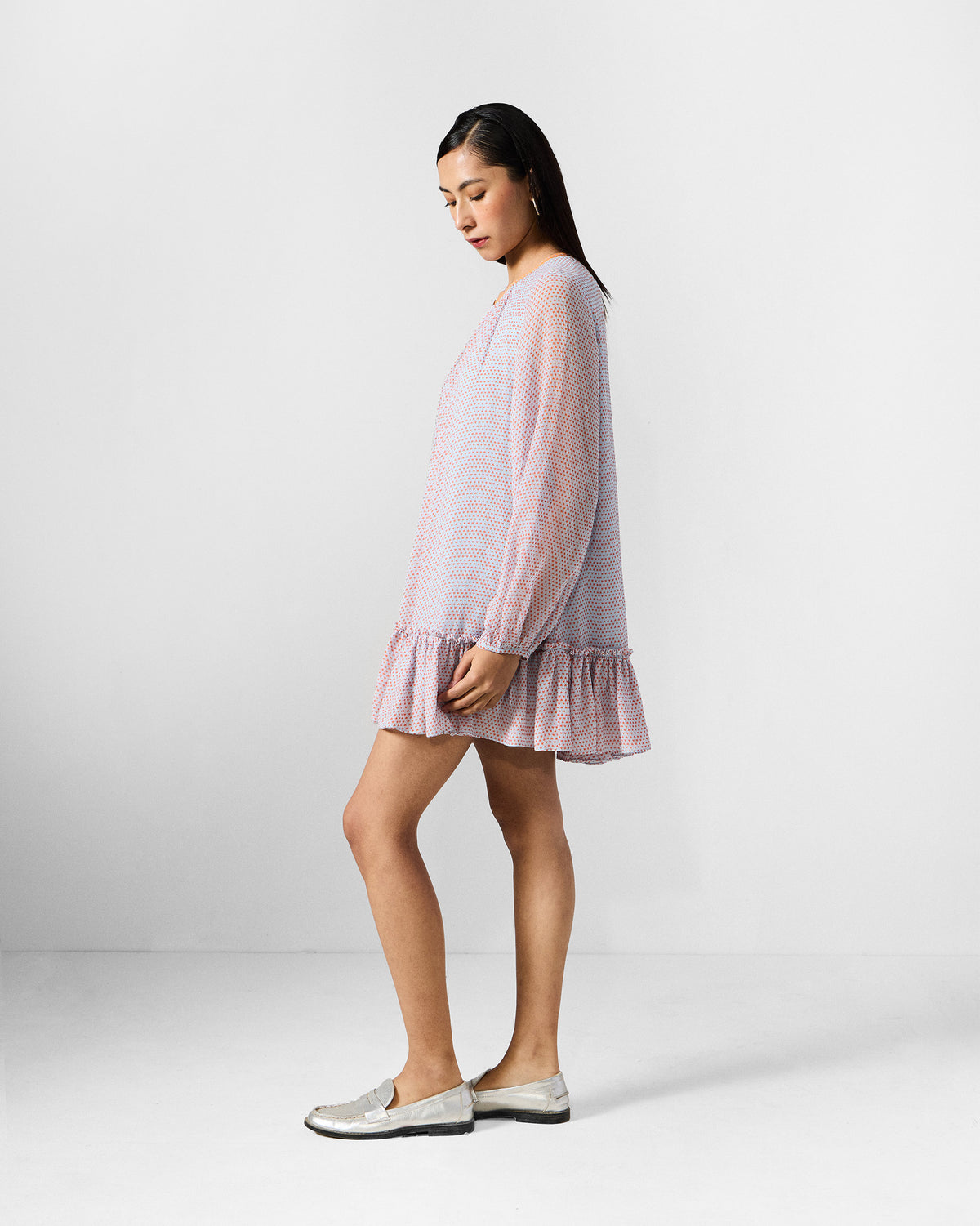 Side view of a blue and orange printed Siya dress with a ruffled hem.