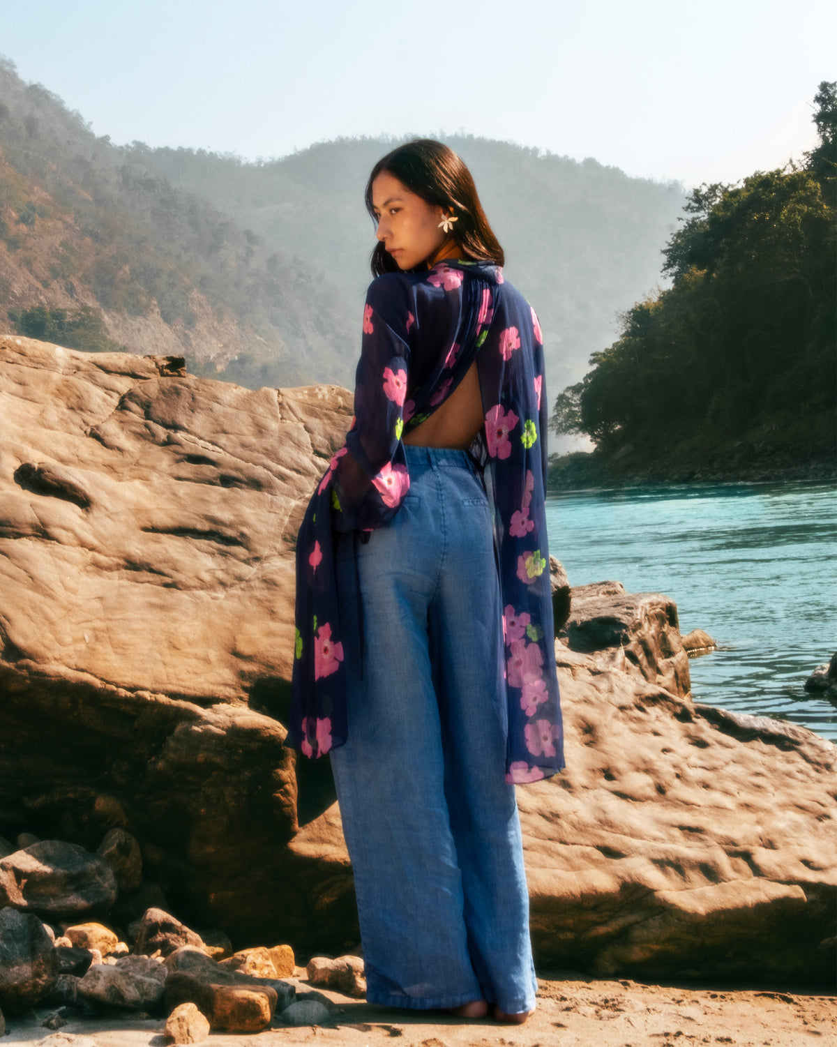 Back of a navy floral Raya dress worn outdoors.