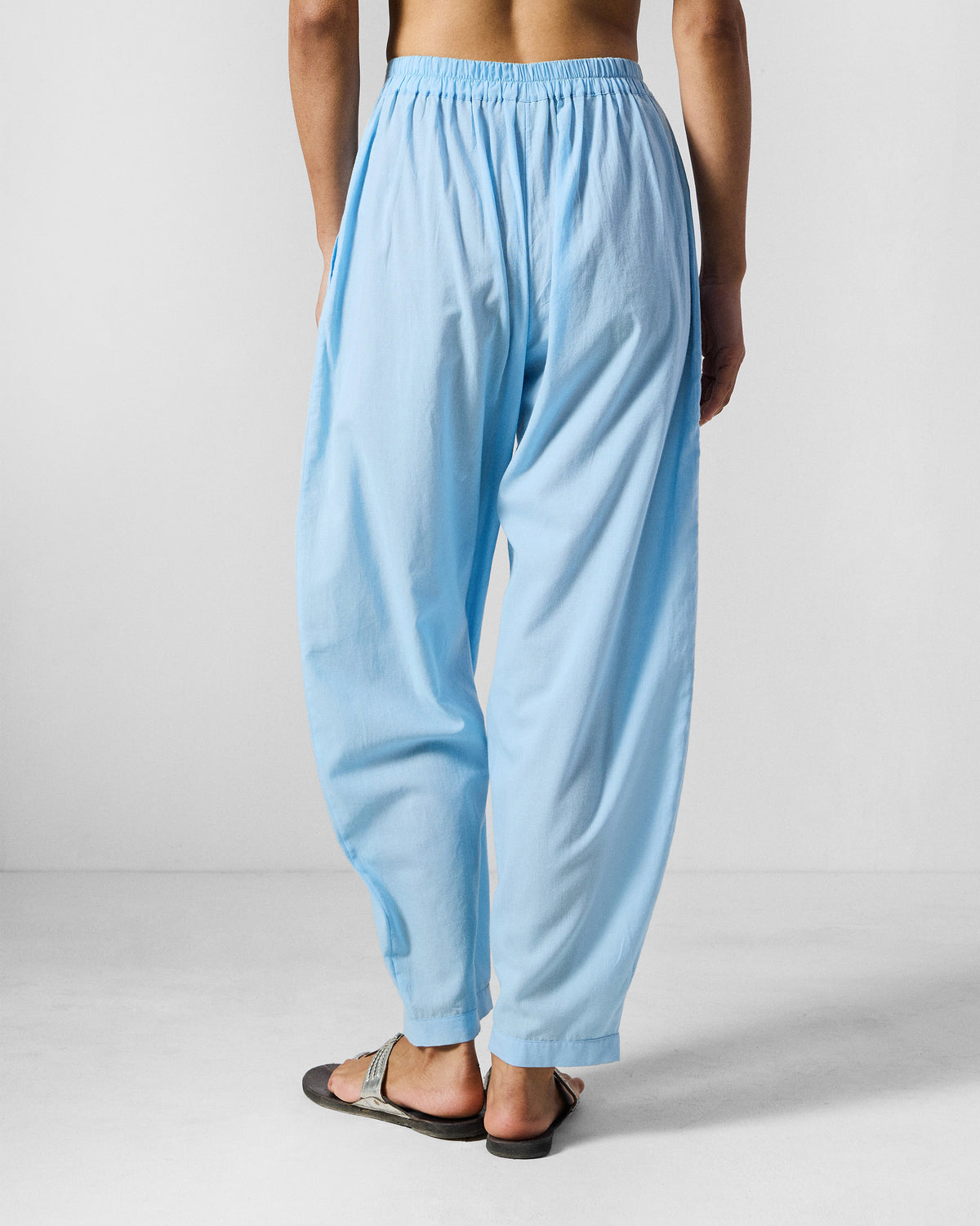 Back of ice blue Aaira Pants with an elastic waistband.