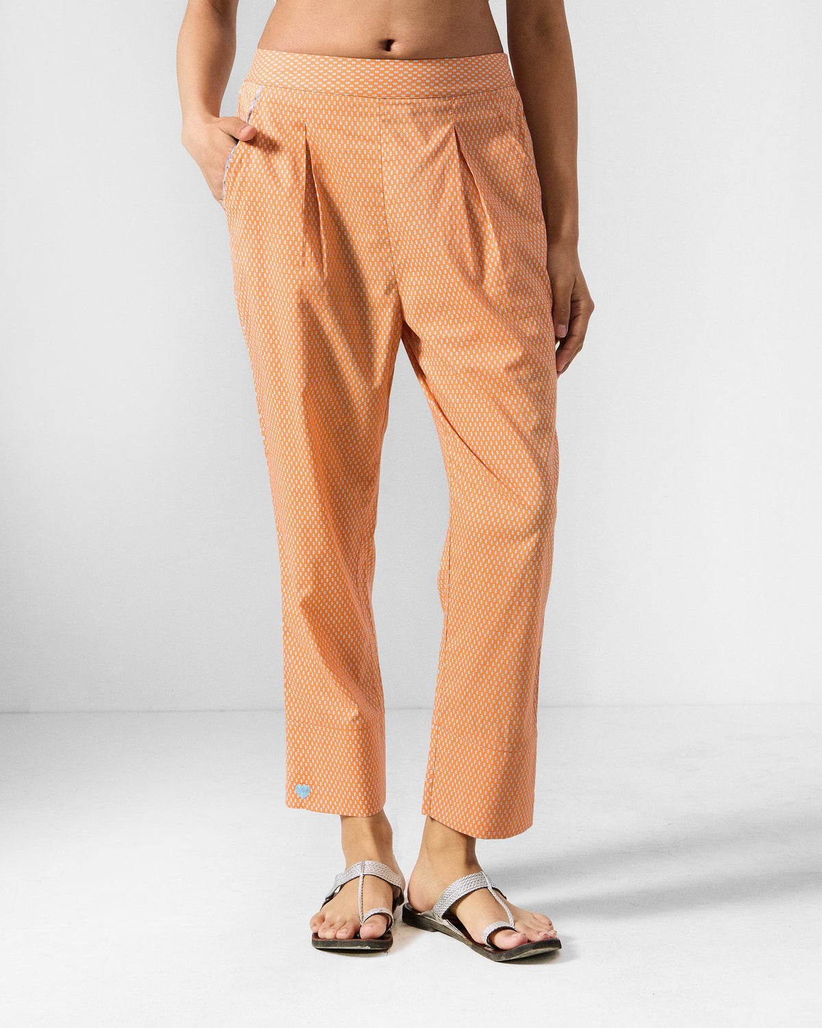 Person wearing orange printed Perch pants.