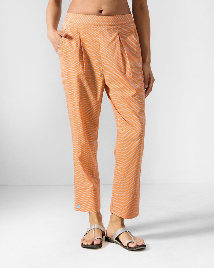 Person wearing orange printed Perch pants.