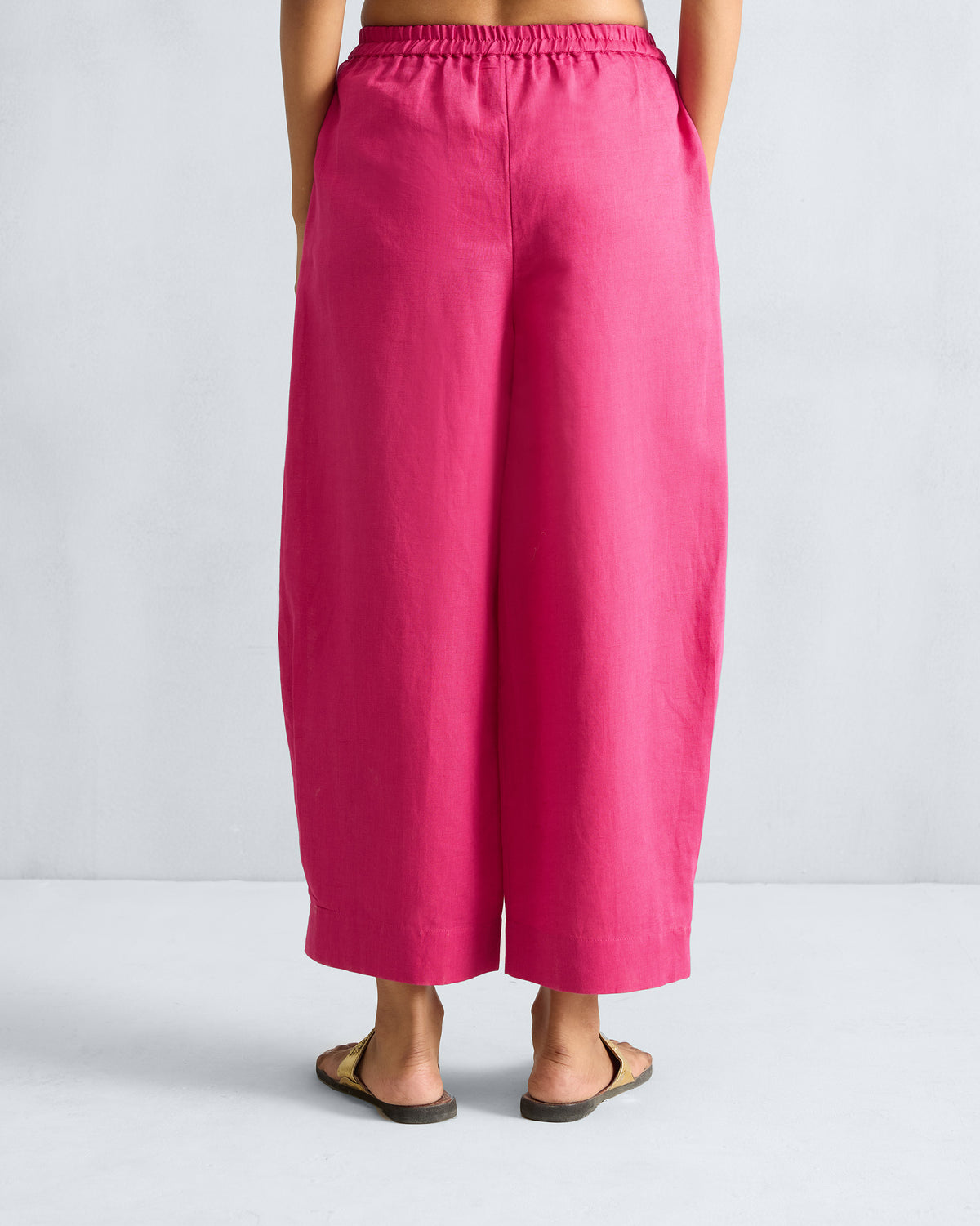 Back of fuchsia Serene pants with a gathered waist and wide legs.