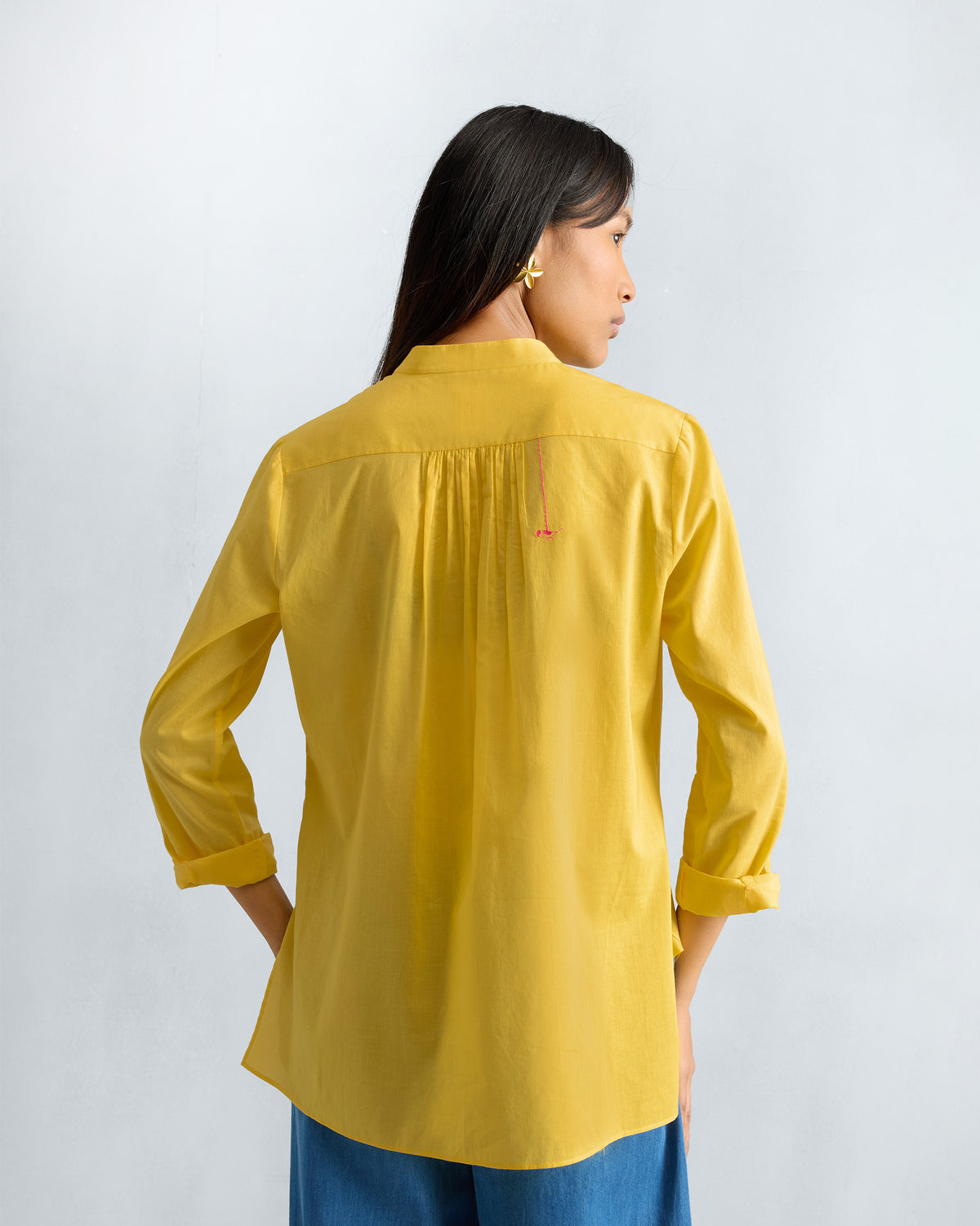 Back of a yellow mandarin collar top with gathers at the yoke.