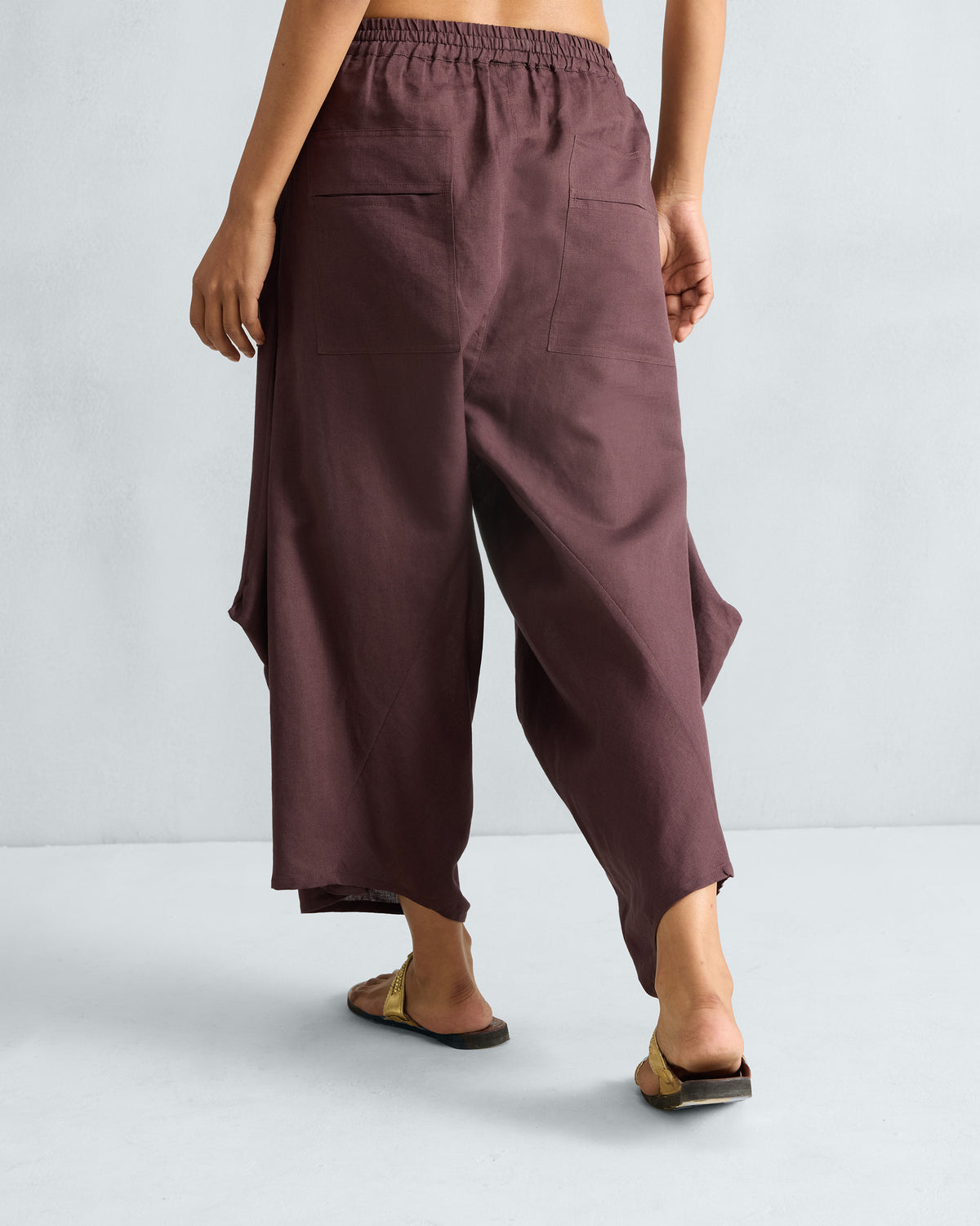 Back of chocolate plum Yoka Trousers with patch pockets.