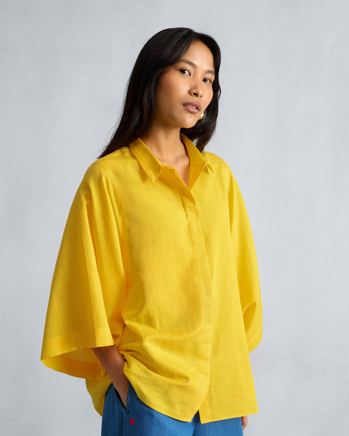 Person wearing a yellow Drop Armhole Shirt with wide sleeves.