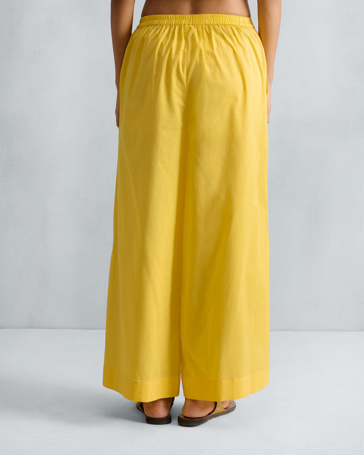 Back of yellow Basic Pyjamas with an elastic waistband.