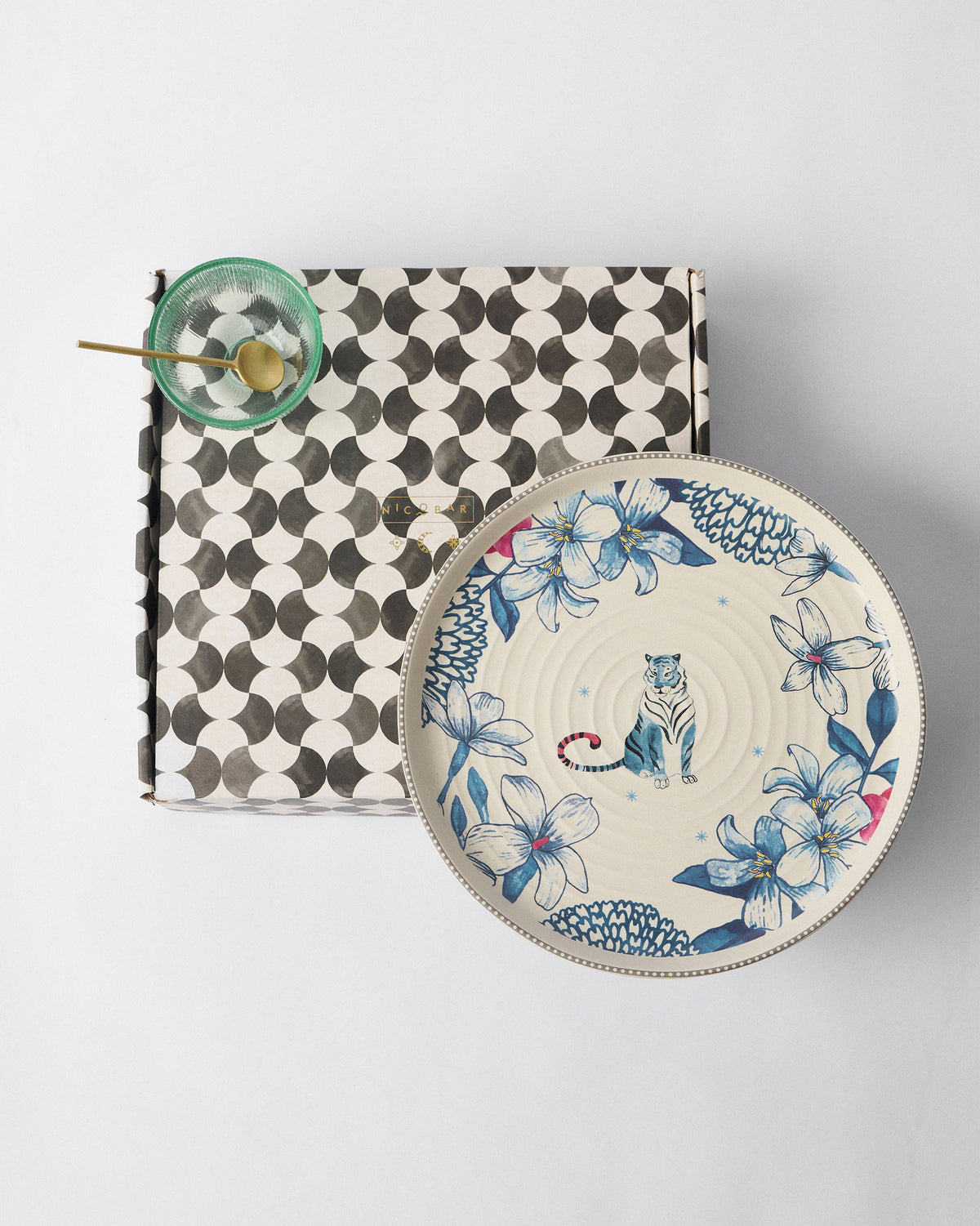 River Tiger platter beside a black-and-white patterned gift box.