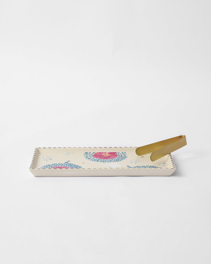 Marigold Cookie Tray With Tong with pink flowers and blue scalloped motifs.