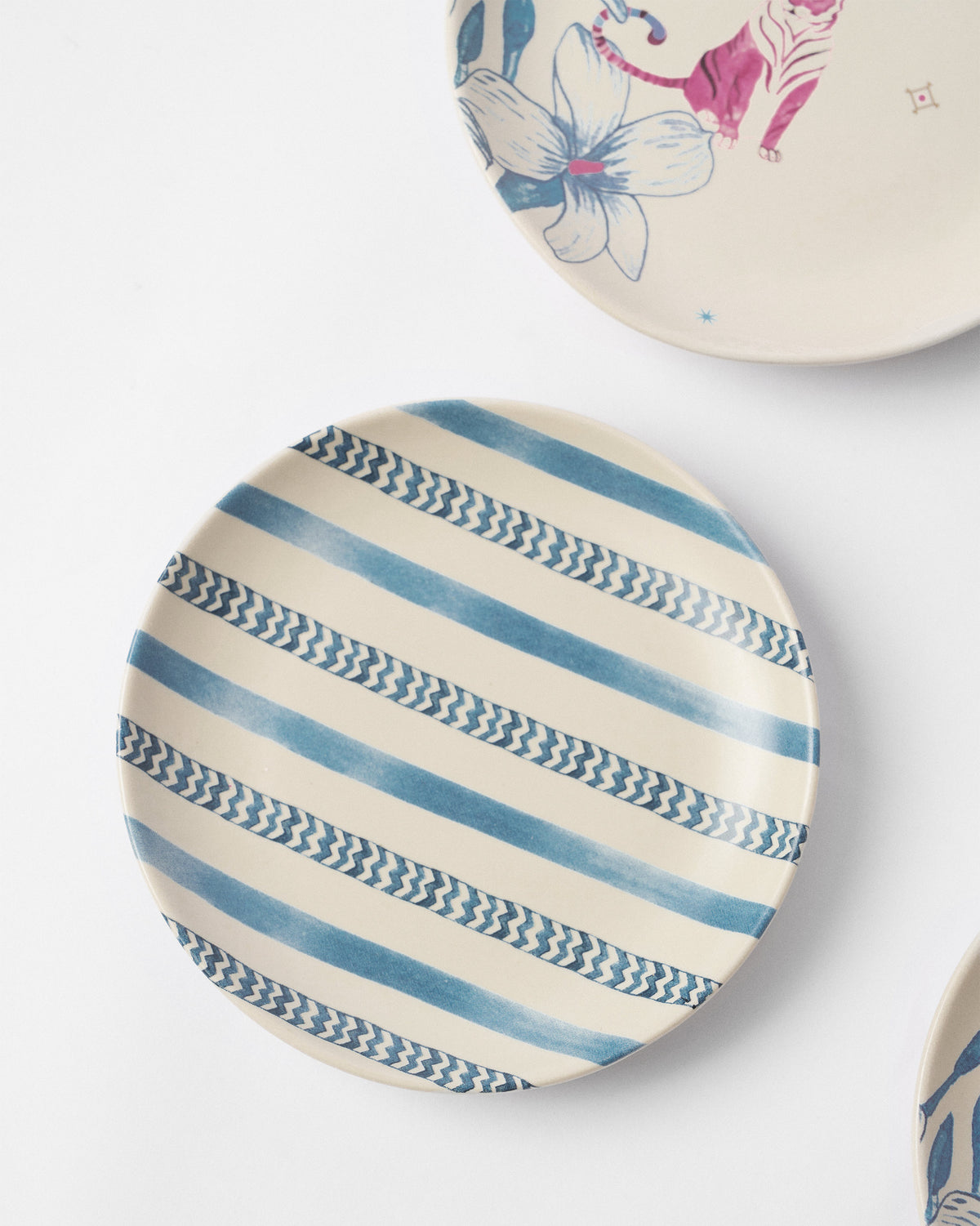 River Tiger tea plate with blue solid and chevron stripes.