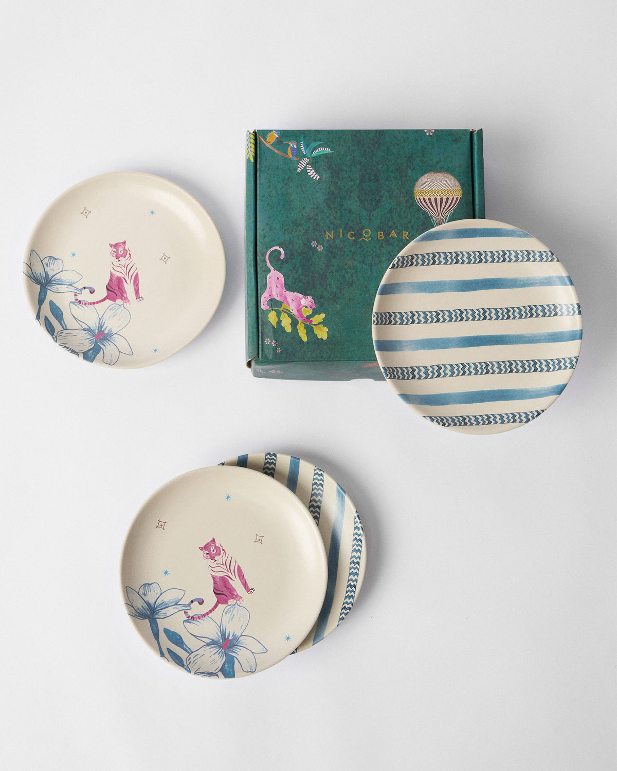 River Tiger tea plates arranged around a teal Nicobar gift box.