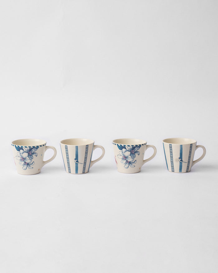 Set of four River Tiger espresso mugs with blue floral and striped bird designs.